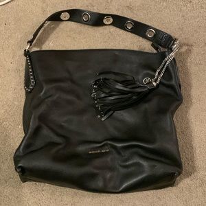 Black leather Michael Kors shoulder bag. Rivits along the shoulder strap.